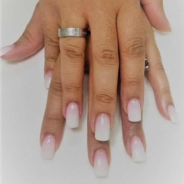 a square-tip manicure complete with a pink & white ombre
						color